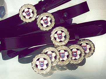 Photograph of belts with custom buckles for football club supporters